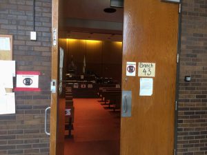 Open door shows interior of empty courtroom