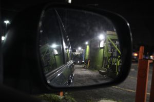 A man sits alone on a closed restaurant’s patio at 11 p.m.
