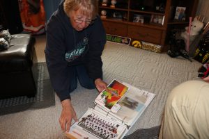 Host family program coordinator Linda Mann shows off one of the scrapbooks she has made for every player she has hosted in Cedar Rapids, Iowa on May 5. (Photo/Mack Liederman)