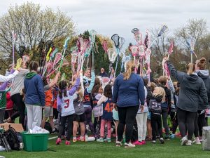 East Ave Lacrosse players and coaches gather after a morning of games between the club’s K-2 teams at Glen Ellyn’s Newton Park on May 1.