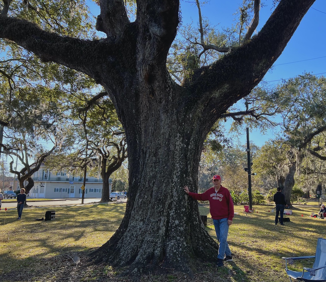 Deacon Joseph M. Clavijo stands next to a tall oak tree in City Park in New Orleans, Louisiana.