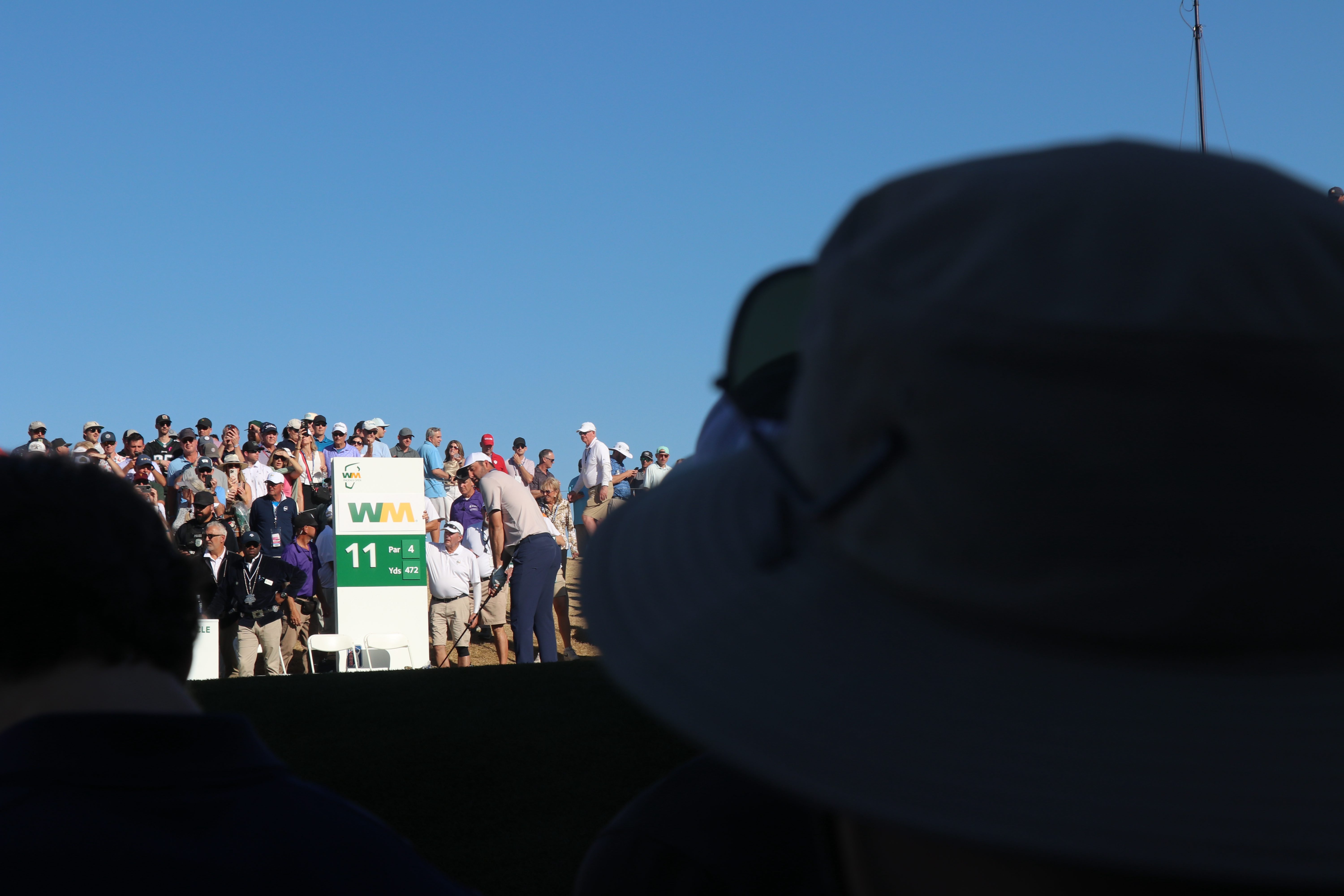 Scottie Scheffler tees off from the 11th hole while crowds watch on Feb. 6, 2025. (Simone Roberts/MEDILL)
