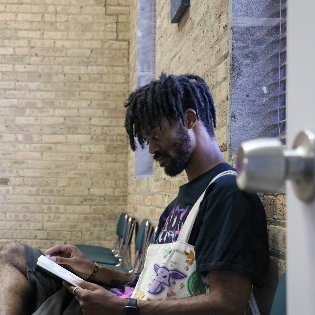 Brandon Jackson writing in his notebook