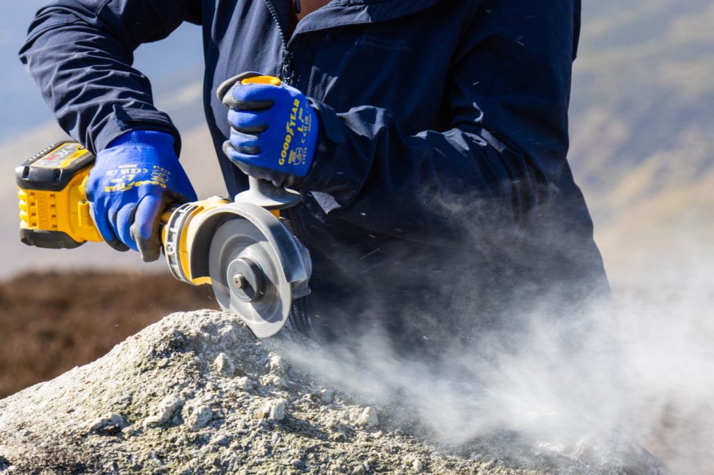 Helen Dulfer carves perpendicular lines into the rock before using a chisel to fully remove the rock sample. (Cathy Ching / Medill)