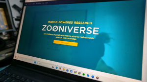 The Zooniverse landing page pictured on a laptop screen.