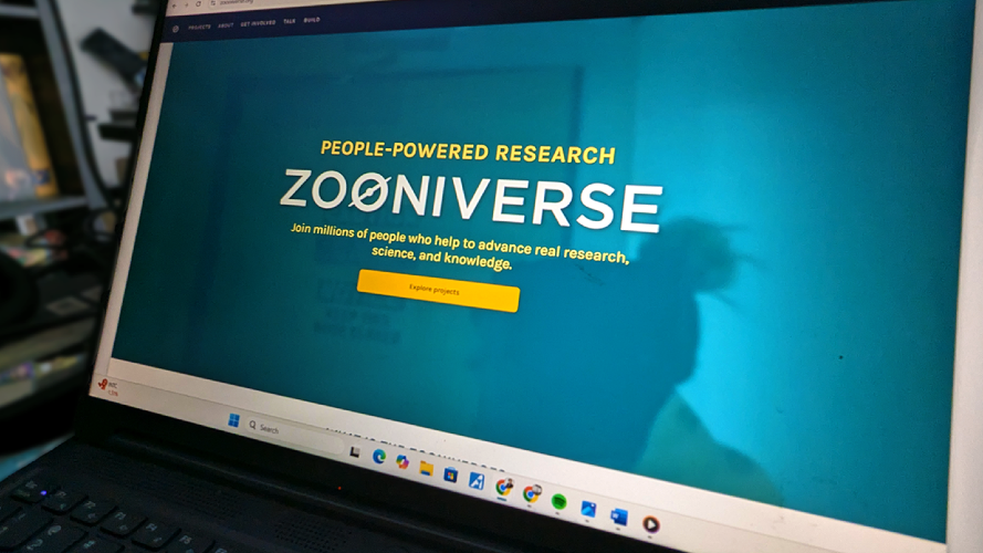 The Zooniverse landing page pictured on a laptop screen.