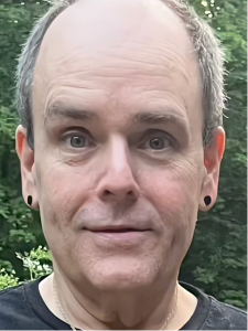 Man's close-up portrait, looking at camera