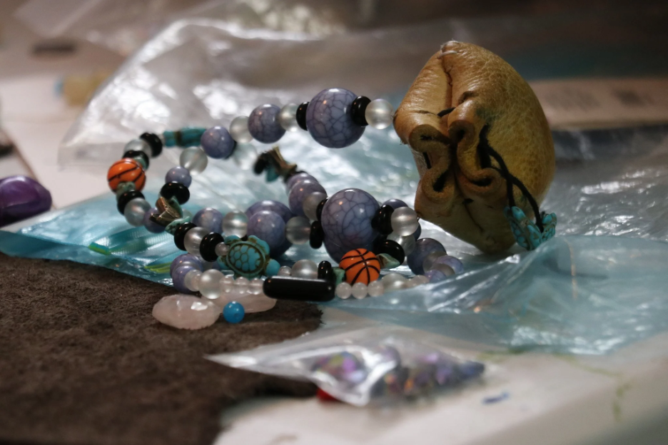 Beaded bracelets and crafting supplies on a table