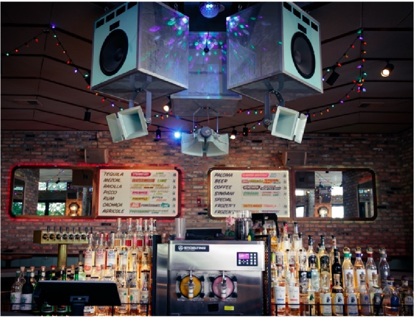 Interior of Estereo, a Chicago bar with Singani menu and liquor bottles