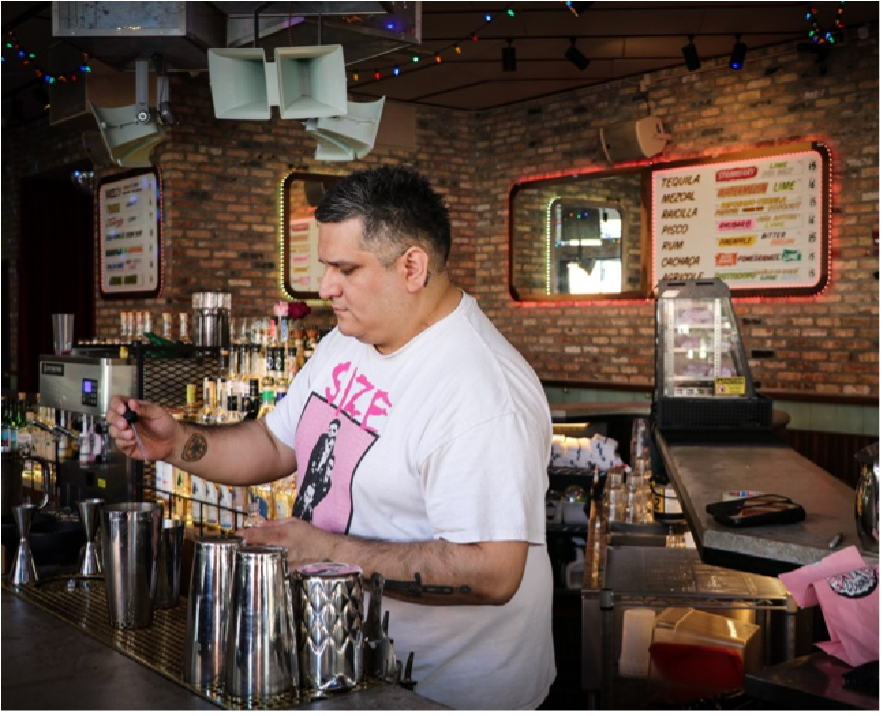 Bartender preparing drink at a bar