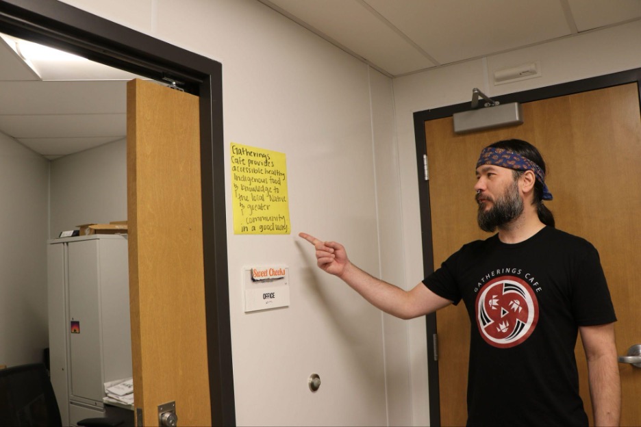 Vernon Defoe points to Gatherings Cafe mission statement