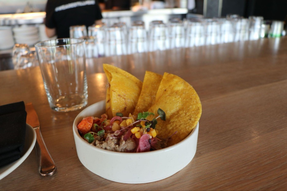Lobster bean dip in small white bowl on counter