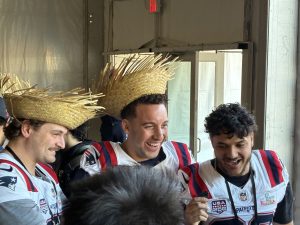Patriots players wearing straw hats and smiling