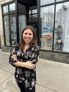 VIlla standing with her arms crossed in front of her art studio