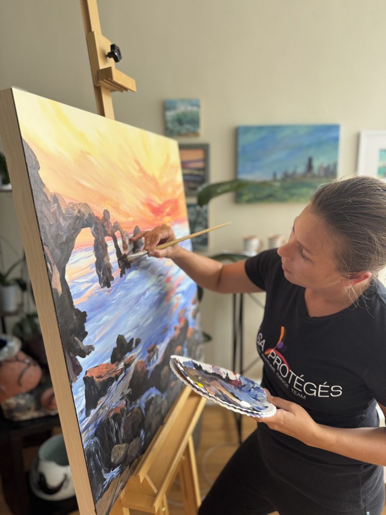 Artist painting a coastal landscape