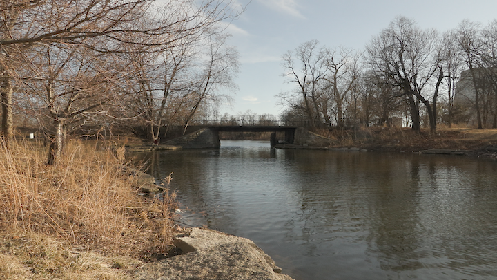 Bridge over a calm river in autumn