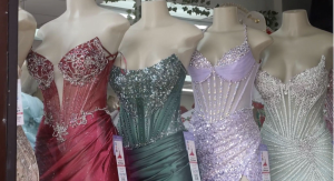 Four prom dresses of different colors displayed on mannequins.