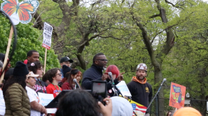 Brandon Johnson speaks at rally surrounded by signs