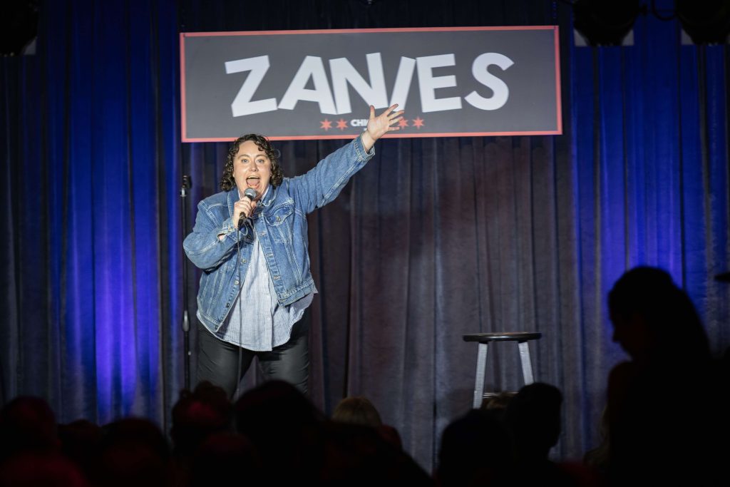 Kait Carmody performing stand-up comedy on stage