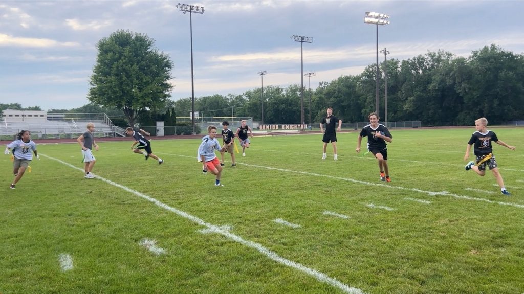 One rusher looks to evade would-be defenders in the Fellowship of Christian Athletes’ Chicago chapter youth flag football game on July 10 (Brock Morgan/MEDILL)