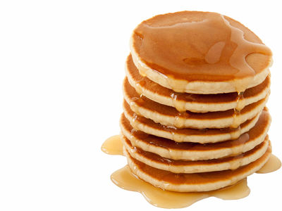 Stack of pancakes drizzled with maple syrup