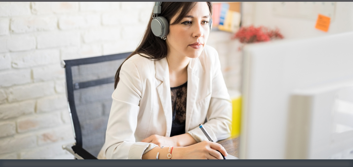 Woman wearing headphones in a home office setting