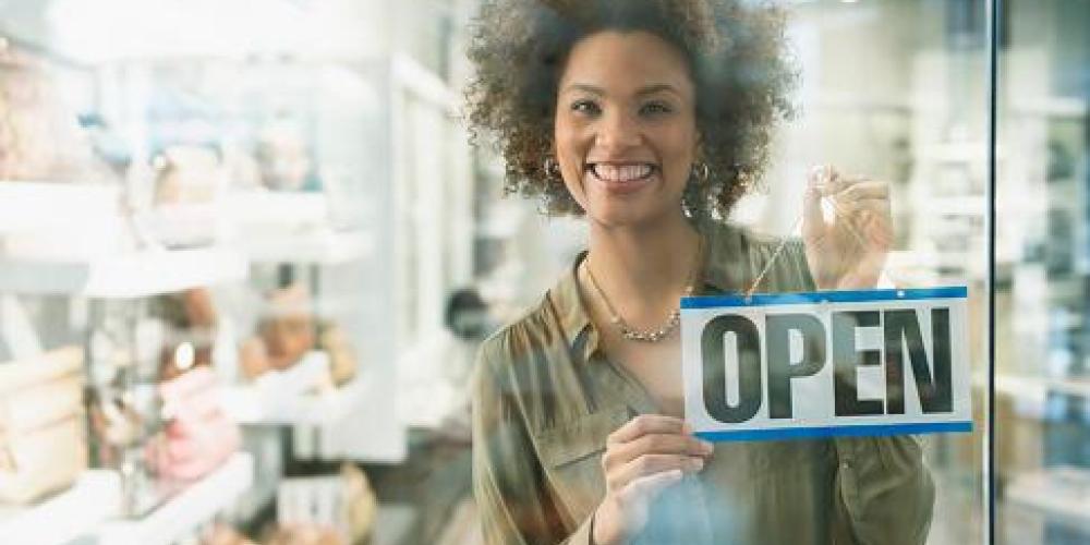 Restarting Your Business Post Covid woman holding an open sign