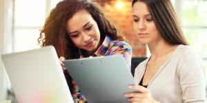 Fund Your Business - What You Need? Where Do You Go? Two business woman going over financial documents