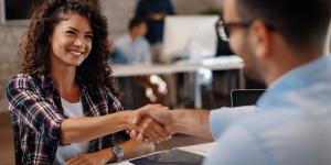Getting Human With Human Resources Young woman signing contracts and handshake with a manager
