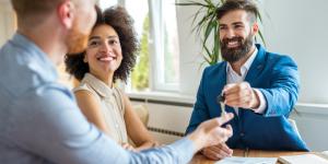 agent giving keys to new business owners