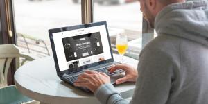 Man creating a website page in a cafe