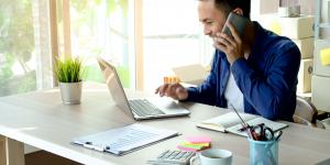Starting a Business, Banking and Insurance Requirements Young business owner using a laptop