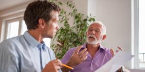 Mentor instructing younger business owner.
