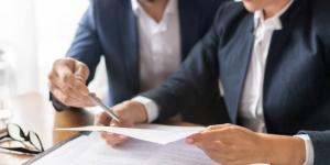 Business people reading a grant document
