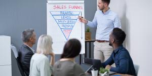 Businesspeople Looking At Man Explaining