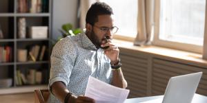 A client watching a webinar on his laptop