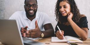 Cheerful african american male and female colleagues discussing project ideas