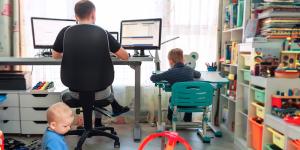 Father with kid working from home during quarantine.