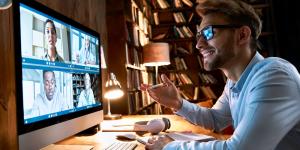 Business man having virtual team meeting on video conference call using computer.