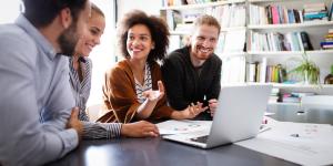 Happy young business colleagues working in office