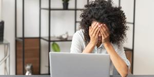 The deadline struggle, young African American female office worker manager with Afro hairstyle feeling tired
