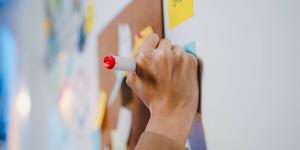 hand writing on a sticky note in red marker