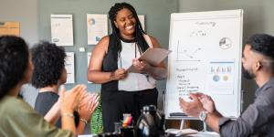 black business woman giving flipchart presentation in the office.