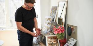Man in eyeglasses inspecting a piece of jewelry