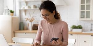 A young woman bookkeeping at her kitchen table