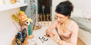 young woman creating handmade earrings
