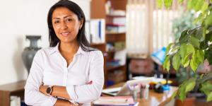 hispanic woman standing infront of her office