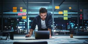 Successful Handsome Creative Director Working on Laptop Computer