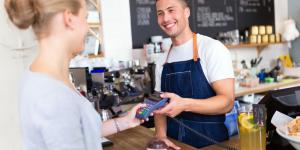 Barista serving customer in coffee shop