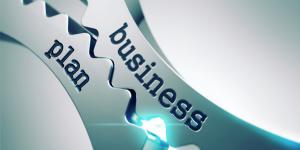 Photo of two interlocking gears with the words 'business' and 'plan' on each gear